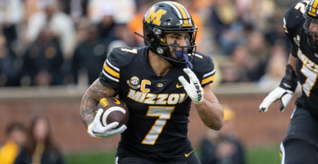 Missouri Tigers running back Cody Schrader on a rushing attempt during a college football game in the SEC.